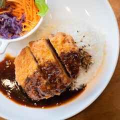 Tonkatsu Pork cutlet top on rice favorite delicious food Japanese that consists of a breaded, deep-fried pork cutlet with gravy Teriyaki sauce juicy.