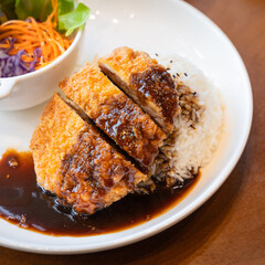 Tonkatsu Pork cutlet top on rice favorite delicious food Japanese that consists of a breaded, deep-fried pork cutlet with gravy Teriyaki sauce juicy.