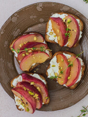 Homemade sandwiches with apricots and cream cheese on bread on a plate
