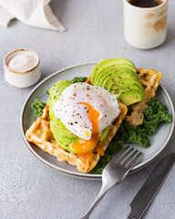 Waffles with avocado and poached egg