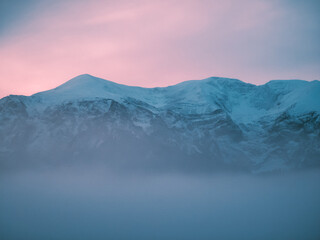 Fototapeta na wymiar Fantastic mountain covered with purple mist, fabulous surreal inspiration landscape