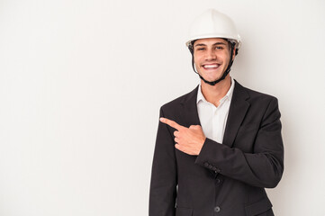 Young architect caucasian man isolated on white background smiling and pointing aside, showing something at blank space.