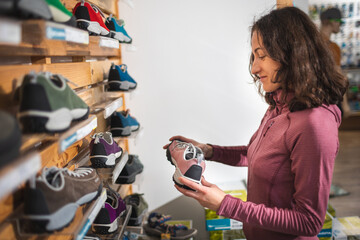 girl chooses shoes in the store