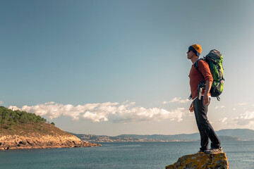 Man exploring the coastline with backpack