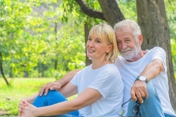 senior couple happy together relaxing outdoor in park in summer