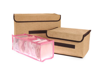 Textile storage cases and organizer with clothes on white background