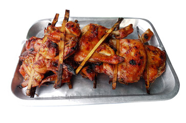 Grilled wings and thighs chicken in a stainless steel tray. Isolated.