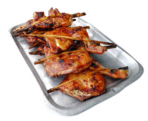 Grilled wings and thighs chicken in a stainless steel tray. Isolated.