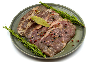 Marinated beef ribeye on a white background. Beef entrecote marinated with olive oil and various spices