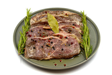 Marinated beef ribeye on a white background. Beef entrecote marinated with olive oil and various spices