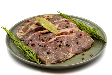 Marinated beef ribeye on a white background. Beef entrecote marinated with olive oil and various spices