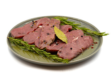 Marinated beef tenderloin on a white background. Beef fillet marinated with olive oil and various spices