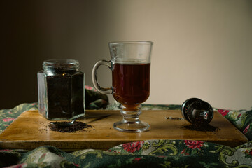strand tea next to a chocolate chip cake. A background tea infuser.