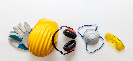 Safety equipment helmet gloves and ear muffs isolated on white background. Personal protective gear