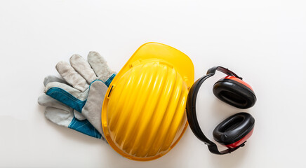 Safety equipment helmet gloves and ear muffs isolated on white background. Personal protective gear