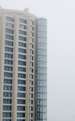 Apartment house. Construction of a multi-storey building. A skyscraper in the fog. Foggy weather.