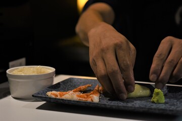 Sushiman compone piatto di sushi