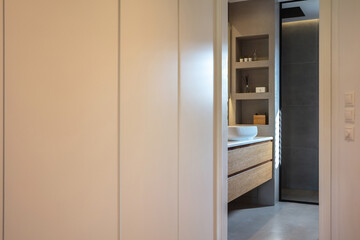 Bedroom wardrobe and bathroom, modern interior design. White clothing closet, and minimal style bath
