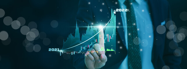 Businessman using finger touch symbol stock graph and chart background,concept growth and market...