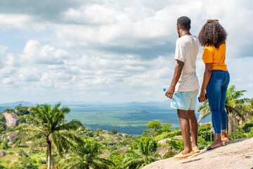 young black man and woman staring into a nature landscape, admiring the view