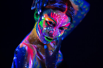 Fashion model woman in neon light, portrait of beautiful model girl with fluorescent make-up, Body...