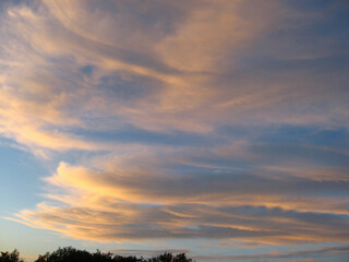 Fototapeta na wymiar Beautiful evening sky with orange clouds at sunset