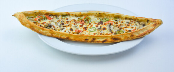 Traditional Turkish pita with mushrooms, cheddar and vegetables, served on a plate, isolated on white