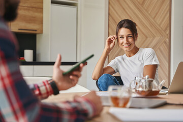 Beautiful elegant woman discussing with business partner in room indoors
