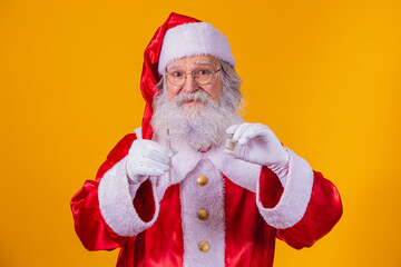 Santa Claus with syringe and vaccine in hand. Santa Claus holding the covid vaccine