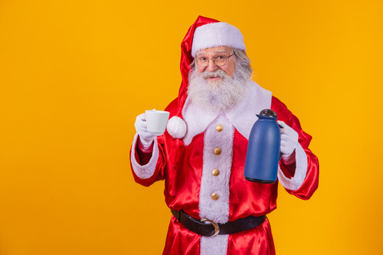 real Santa Claus holding the coffee bottle and a cup