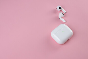 white wireless headphones on background