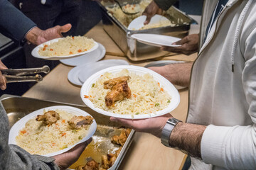 Stockholm, Sweden People eating rice and chicken at the Islamic Cultural Center in Rinkeby, an immigrant suburb, after an community youth event.