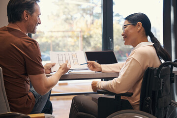 Happy female with paraleria discussing business with man