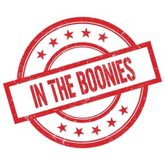 IN THE BOONIES text written on red vintage round stamp.