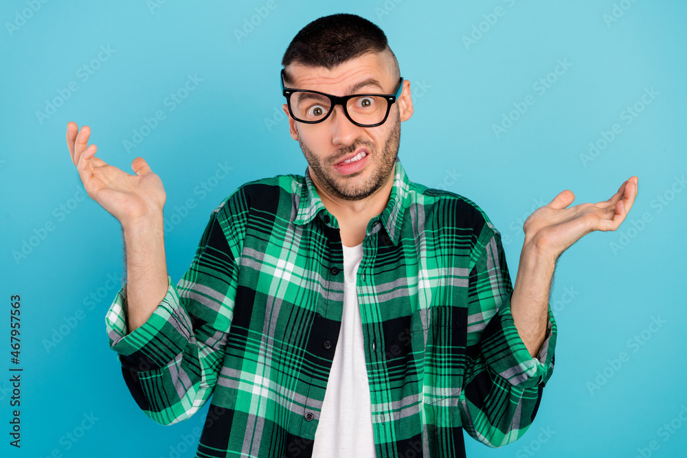 Canvas Prints photo of unhappy upset silly man shrug shoulders clueless no idea wear glasses isolated on blue colo