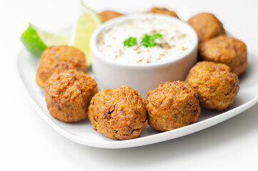 Falafels, gently spiced blend of sweet potato, chickpeas and onion with a sour dip