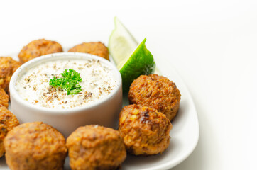 Falafels, gently spiced blend of sweet potato, chickpeas and onion with a sour dip