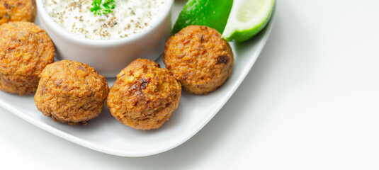 Falafels, gently spiced blend of sweet potato, chickpeas and onion with a sour dip