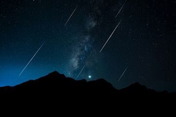 Panorama Milky Way. Night sky with stars and hooting stars with silhouette of dark the mountain. Space background