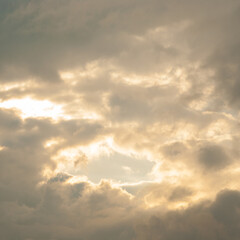 Background sky blue with filled fluffy natural clouds and natural sunlight.The atmosphere in summer..