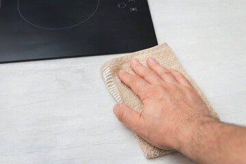 person cleaning a surface with towel
