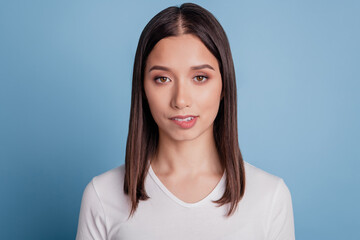 Photo of young attractive woman bite lips teeth flirty romantic feelings date isolated over blue color background