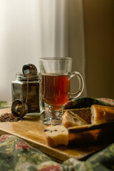 strand tea next to a chocolate chip cake. A background tea infuser.