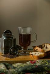 strand tea next to a chocolate chip cake. A background tea infuser.