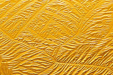 Gold patterns from frost on glass as a background.