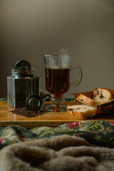 strand tea next to a chocolate chip cake. A background tea infuser.