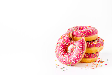 Close up of pink frosted donuts with colorful sprinkles
