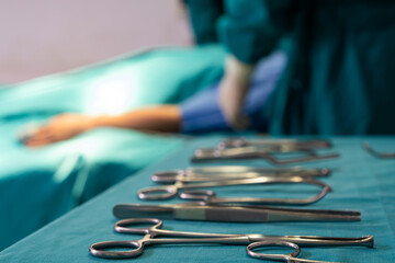 Doctor or nurse assistance select surgical knife  while doing surgery for patient inside of the hospital. Healthcare expertise, professional service.