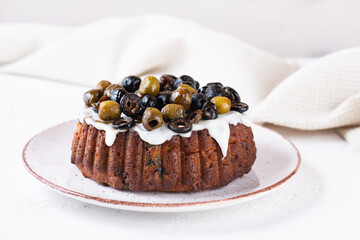 Vegan muffin with olives on a plate. Sugar, gluten and lactose free.