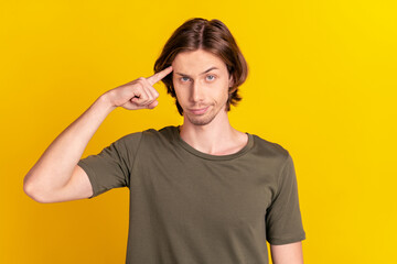 Photo of young guy finger touch head moody accuse stupid misunderstanding isolated over yellow...